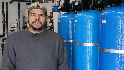 Water Operator, Byron Porter, standing beside new water treatment equipment
