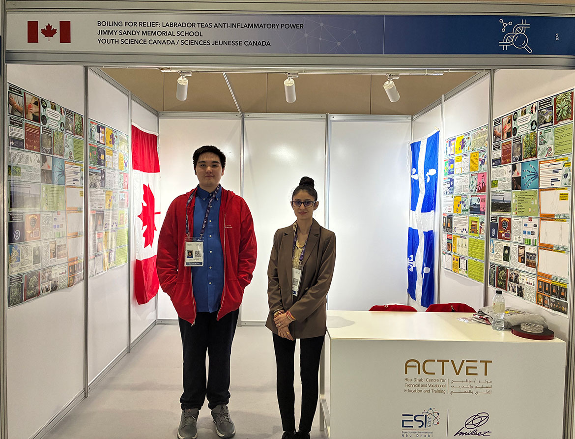 Aiden-James Einish and his science teacher, Shaveta Sharma, next to his booth at the MILSET International Science Fair