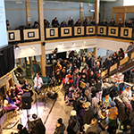 Wide shot of the hall during a performance of traditional songs.