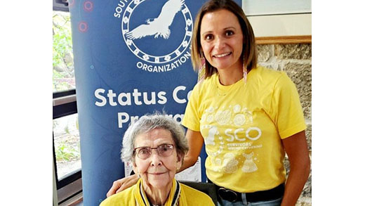 Two people sharing a smile during a community gathering.