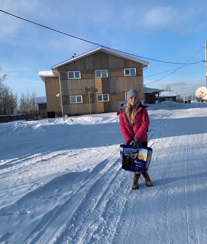 Kristen Chodoriwsky standing on the side of a road in a northern community.